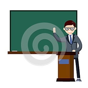 School teacher stands near blackboard.