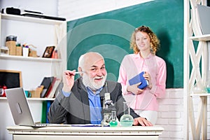 School time. biology lesson. Science and biotechnology research. mature teacher with microscope. student and tutor with