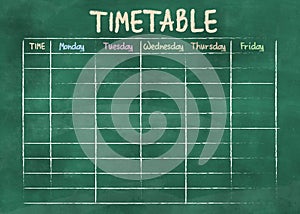 School timetable or class schedule on green chalkboard
