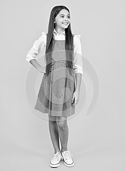 School uniform. Elegant fashion teenager child girl posing in studio. Trends kids clothes.