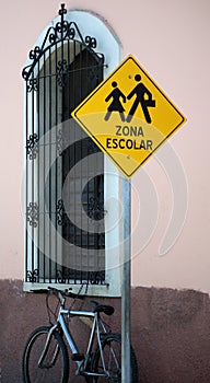 School zone sign by window of elementary school. photo