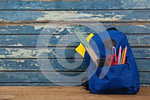 Schoolbag on wooden background photo