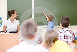 Schoolboy answers questions of teachers near a school board