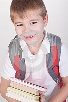 Schoolboy with books and backpack