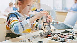 Schoolboy Builds / Constructs Small Robot and Uses Laptop to Program Software for Robotics Enginee