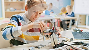 Schoolboy Builds / Constructs Small Robot and Uses Laptop to Program Software for Robotics Enginee