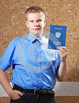 Schoolboy with the certificate about completion of education at school.Portrait