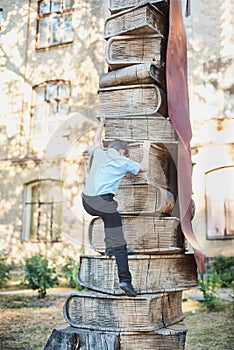 schoolboy climbs the levels of knowledge from books. School lessons. Back to school