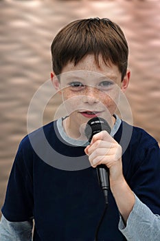 Schoolboy giving a performance and entertains the people photo