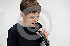 Schoolboy giving a performance and entertains the people photo