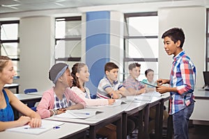 Schoolboy giving presentation in classroom