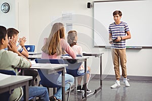 Schoolboy giving presentation in classroom