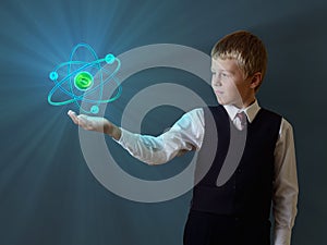 Schoolboy holding glowing atom