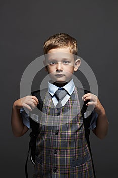 Schoolboy with knapsack.stylish funny child in suit and tie. ready to school