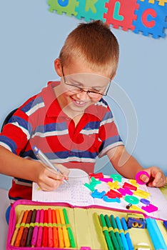 Schoolboy learning to write letters