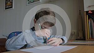 Schoolboy make homework and using drawing compass and ruler to draw a car