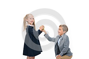 Schoolboy presenting apple to girl