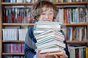 Schoolboy read books, Cute boy reading book in library