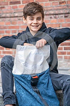 Schoolboy with school backpack. Back to school. Teenagers leisure