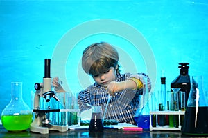 Schoolboy. School concept. Ready for school. Science. Cheerful smiling little boy having fun against blue wall. Child in