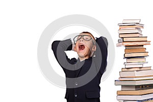 Schoolboy screaming near the huge stack of books