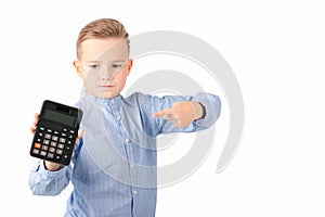 Schoolboy shows at calculator. Portrait of funny cute 10s boy .White background