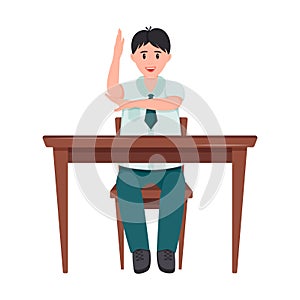 A schoolboy is sitting at a Desk. The student boy raised his hand to answer. The child smiles. School lesson. Elements