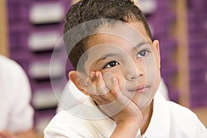 Schoolboy sitting in primary class