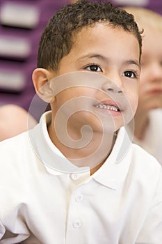 Schoolboy sitting in primary class