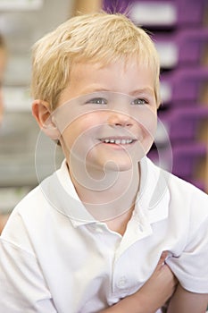 Schoolboy sitting in primary class