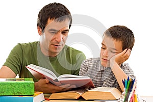 Schoolboy sleeping while his father reading