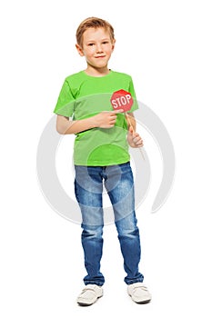 Schoolboy with small Stop sign in his hand