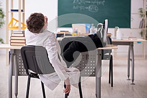 Schoolboy studying chemistry in the classroom