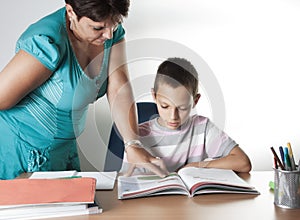 Schoolboy Studying In Classroom With Teacher