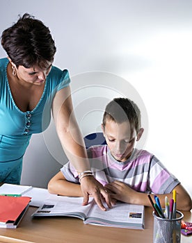 Schoolboy Studying In Classroom With Teacher