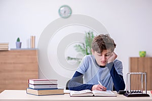 Schoolboy studying physics at home