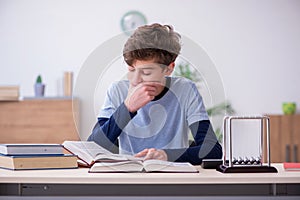 Schoolboy studying physics at home