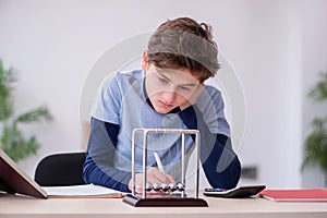 Schoolboy studying physics at home