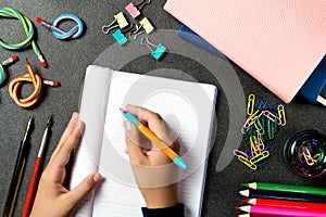 Schoolboy at the table with stationery doing homework. Home schooling. Space for text and ads