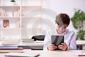 Schoolboy in tele-education concept in the classroom