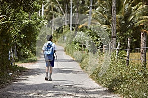 Schoolboy in uniform is walking to school