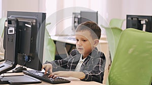 Schoolboy using computer in a class