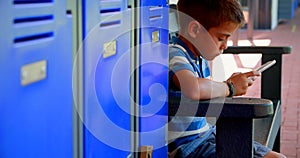 Schoolboy using mobile phone in locker room 4k