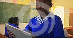Schoolboy using tablet in a lesson at a township school 4k