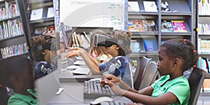 Schoolboy using virtual reality headset in computer room