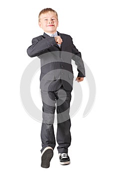 Schoolboy wearing accurate suit is walking