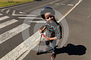 Schoolboy wearing a cycling helmet on a pedestrian crossing