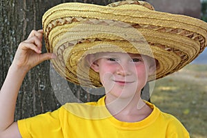 Schoolboy wears a big mexican straw hat