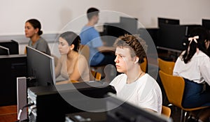 Schoolboy working with computers in classroom