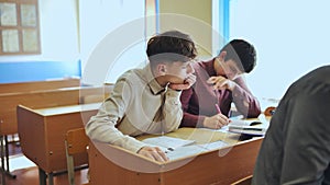 Schoolboys at a desk during class. photo